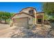 Charming two-story home featuring a two-car garage and desert landscaping at 2454 W Camp River Rd, Queen Creek, AZ 85144