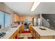 Bright kitchen features stainless steel appliances, light cabinets, and an island with seating at 2454 W Camp River Rd, Queen Creek, AZ 85144