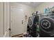 Laundry room with modern washer and dryer, plus extra storage shelves at 2454 W Camp River Rd, Queen Creek, AZ 85144