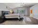 The main bedroom includes wood flooring, a ceiling fan, a picture window, and a step-up platform at 2454 W Camp River Rd, Queen Creek, AZ 85144