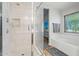 Modern bathroom features a glass enclosed shower with tile surround at 2454 W Camp River Rd, Queen Creek, AZ 85144