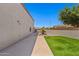 Side yard with well manicured grass and a beautiful tree at 2454 W Camp River Rd, Queen Creek, AZ 85144