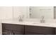 Modern bathroom vanity with double sinks, quartz countertop, and dark wood cabinetry at 2668 E San Miguel Dr, Casa Grande, AZ 85194