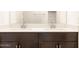 Modern bathroom vanity featuring double sinks, white countertop, and dark brown cabinets at 2668 E San Miguel Dr, Casa Grande, AZ 85194