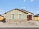 Charming single-story home with a red door and a well-maintained, low maintenance front yard at 2668 E San Miguel Dr, Casa Grande, AZ 85194