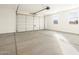 Spacious garage with a large garage door and side windows at 2668 E San Miguel Dr, Casa Grande, AZ 85194