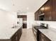 Modern kitchen features stainless steel appliances, dark wood cabinets, and granite countertops at 2668 E San Miguel Dr, Casa Grande, AZ 85194