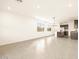 Open-concept living space with tile flooring, bright windows, and a modern kitchen at 2668 E San Miguel Dr, Casa Grande, AZ 85194
