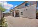 Exterior shot of the backyard showing the patio, privacy fence, brick paved ground, and covered patio at 2831 W Margy Ct, Phoenix, AZ 85017