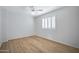 Bright bedroom with wood flooring, a ceiling fan, and a window with shutters at 2831 W Margy Ct, Phoenix, AZ 85017