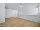 Spacious bedroom area with hardwood floors, ceiling fan, and bright white walls at 2831 W Margy Ct, Phoenix, AZ 85017