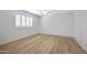 Bright bedroom featuring hardwood floors, a ceiling fan, and shuttered windows at 2831 W Margy Ct, Phoenix, AZ 85017