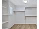 Walk-in closet featuring adjustable shelves and wood flooring at 2831 W Margy Ct, Phoenix, AZ 85017