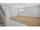 Bright, open-concept living room featuring hardwood flooring, modern lighting, and access to upper level at 2831 W Margy Ct, Phoenix, AZ 85017