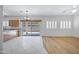 Bright, open-concept living room with hardwood flooring, modern lighting, and access to outdoor patio at 2831 W Margy Ct, Phoenix, AZ 85017