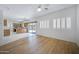Bright, open-concept living room featuring hardwood flooring and views into the kitchen and outdoor patio at 2831 W Margy Ct, Phoenix, AZ 85017