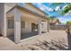 Exterior view of a covered patio with tan columns and brick floor, providing shade and a spot for relaxing at 2831 W Margy Ct, Phoenix, AZ 85017