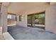 Covered patio with sliding glass doors and smooth floor, transitioning seamlessly between indoor and outdoor living at 2831 W Margy Ct, Phoenix, AZ 85017