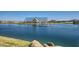 Scenic view of a tranquil community lake with a covered seating area, providing a peaceful spot for residents to relax at 2952 E Lucky Horseshoe Ln, San Tan Valley, AZ 85140