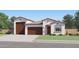 Charming single-story home with a three-car garage, desert landscaping, and a welcoming front entrance at 2952 E Lucky Horseshoe Ln, San Tan Valley, AZ 85140