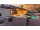 Inviting backyard with a sparkling pool, desert landscaping, and cozy patio with string lights at 3001 E Winchcomb Dr, Phoenix, AZ 85032