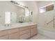 Bright bathroom featuring double sinks, a large mirror, and a shower-tub combo at 3001 E Winchcomb Dr, Phoenix, AZ 85032