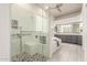 Modern bathroom with a glass shower, bench seating, and stylish gray vanity at 3001 E Winchcomb Dr, Phoenix, AZ 85032