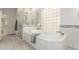 Bright bathroom with a soaking tub, separate shower, and modern finishes at 3001 E Winchcomb Dr, Phoenix, AZ 85032