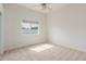 Bedroom with neutral carpet, a ceiling fan, and a large window overlooking the yard at 3001 E Winchcomb Dr, Phoenix, AZ 85032