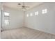 Neutral-toned bedroom with carpet flooring, a ceiling fan, and bright windows at 3001 E Winchcomb Dr, Phoenix, AZ 85032
