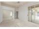 Open bedroom layout with mirrored closet doors and access to a patio at 3001 E Winchcomb Dr, Phoenix, AZ 85032