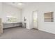 Bright bonus room with built-in desk and shutters on the windows at 3001 E Winchcomb Dr, Phoenix, AZ 85032