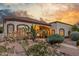 Lovely home with a colorful desert garden, stucco exterior, and beautiful sunset at 3001 E Winchcomb Dr, Phoenix, AZ 85032
