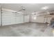 Spacious three-car garage with automatic door openers, built-in shelving, and lots of natural light at 3001 E Winchcomb Dr, Phoenix, AZ 85032