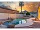 Back yard featuring desert landscaping and a free form pool with rock waterfall feature, and mountain views at 3001 E Winchcomb Dr, Phoenix, AZ 85032