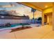 Back yard featuring desert landscaping and a free form pool with rock waterfall feature, and sunset view at 3001 E Winchcomb Dr, Phoenix, AZ 85032