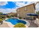 Private backyard with a stunning pool, shaded patio, and desert foliage at 30013 N Candlewood Dr, San Tan Valley, AZ 85143
