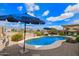 Gorgeous backyard with a sparkling pool, lounge chairs, and desert views at 30013 N Candlewood Dr, San Tan Valley, AZ 85143