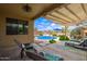 Inviting backyard pool area with patio, lounge chairs, and lush landscaping at 30013 N Candlewood Dr, San Tan Valley, AZ 85143