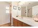 Bathroom features a vanity with mirror, cabinets, drawers, and a window at 30013 N Candlewood Dr, San Tan Valley, AZ 85143