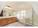 A bathroom features double sinks, a bath tub, and glass enclosed shower at 30013 N Candlewood Dr, San Tan Valley, AZ 85143