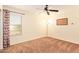 Neutral bedroom has neutral decor and is completed with a ceiling fan and window at 30013 N Candlewood Dr, San Tan Valley, AZ 85143