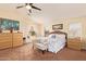 A primary bedroom with a ceiling fan, sitting area and a view to the large window at 30013 N Candlewood Dr, San Tan Valley, AZ 85143
