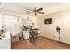 Neutral bedroom is complete with a ceiling fan and desk area at 30013 N Candlewood Dr, San Tan Valley, AZ 85143
