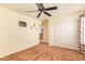 Bedroom with neutral decor is complete with a ceiling fan, window, and closet at 30013 N Candlewood Dr, San Tan Valley, AZ 85143