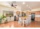 Bright kitchen features a central island with barstool seating and modern stainless steel appliances at 30013 N Candlewood Dr, San Tan Valley, AZ 85143