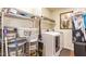 Functional laundry room with modern appliances and shelving for storage at 30013 N Candlewood Dr, San Tan Valley, AZ 85143