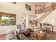 Spacious living room with hardwood floors, fireplace, and staircase at 30013 N Candlewood Dr, San Tan Valley, AZ 85143
