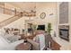 A spacious living room boasts a fireplace, wood floors, and an open staircase to the upper level at 30013 N Candlewood Dr, San Tan Valley, AZ 85143