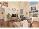 Spacious living room featuring hardwood floors, fireplace, and high ceilings at 30013 N Candlewood Dr, San Tan Valley, AZ 85143